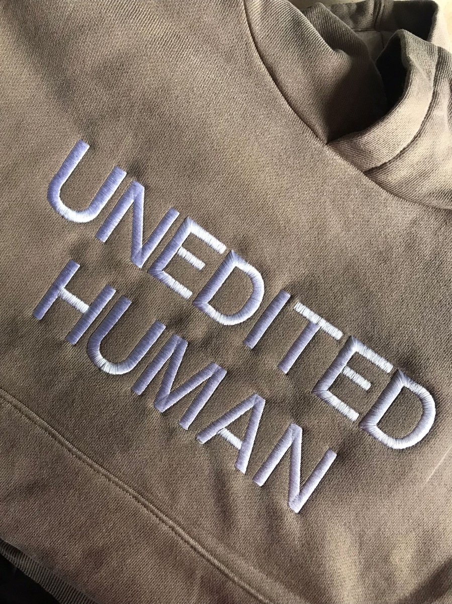 Macro of UNEDITED HUMAN raised embroidery